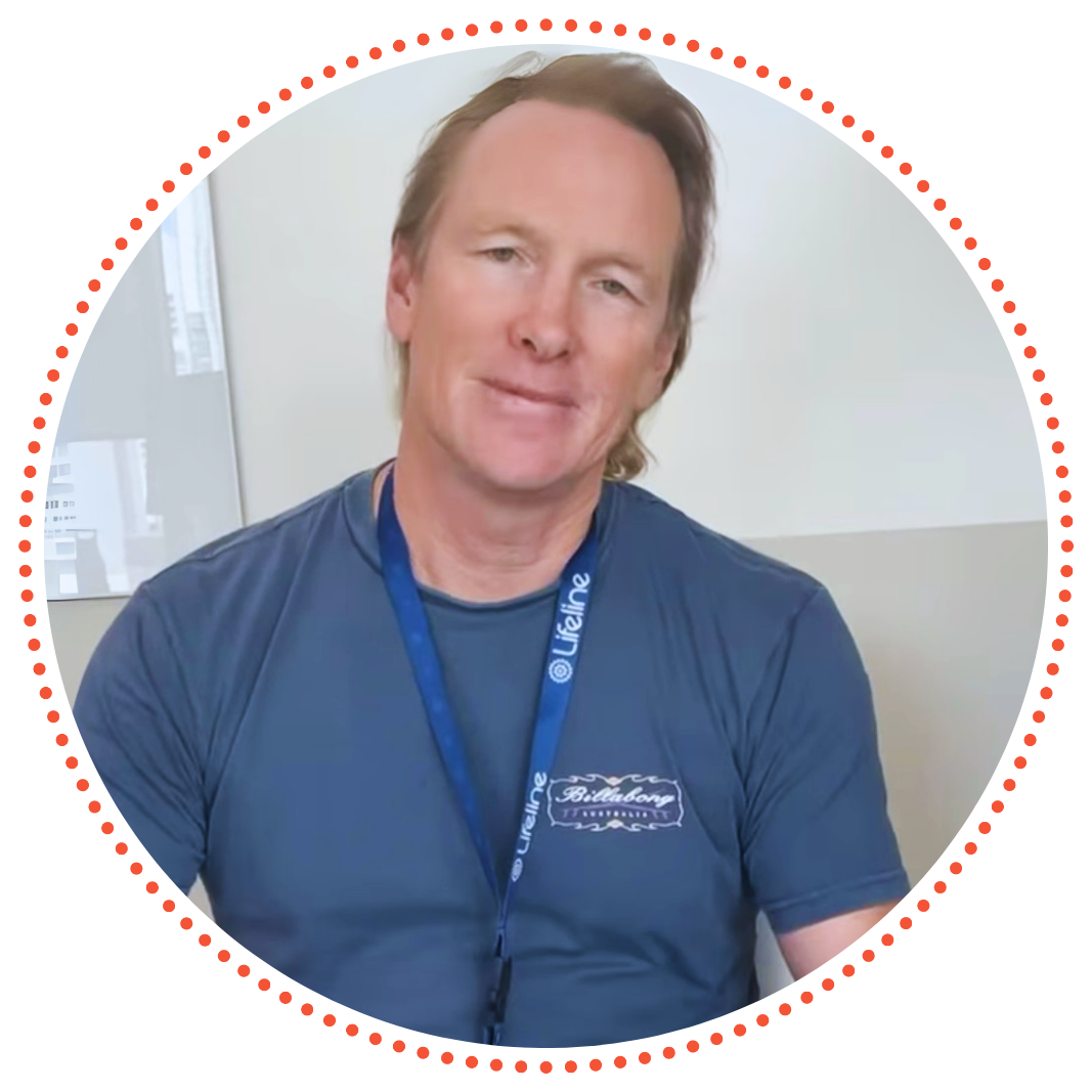 Geoff, a Lifeline Queensland Crisis Support Volunteer is smiling warmly. Geoff is wearing a Lifeline layard while on site at the Brisbane Crisis Support call centre. Geoff, a Lifeline Queensland Crisis Support Volunteer is smiling warmly. Geoff is wearing a Lifeline layard while on site at the Brisbane Crisis Support call centre.