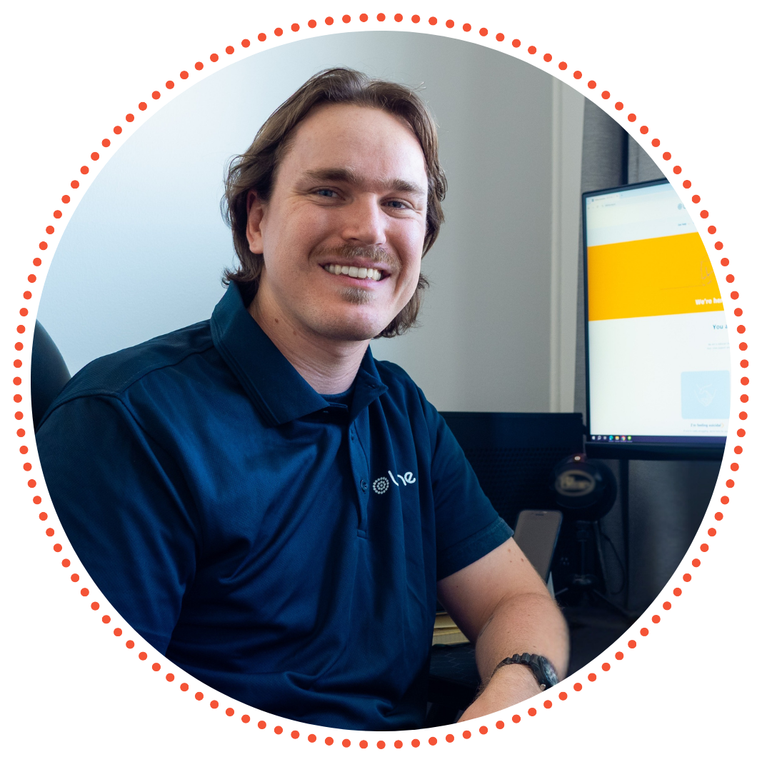 Orion, A Lifeline Queensland Call Coach is sitting at his desk, ready to support Crisis Supporter Volunteers to answer calls to Lifeline's 13 11 14 Crisis Support Line Orion, A Lifeline Queensland Call Coach is sitting at his desk, ready to support Crisis Supporter Volunteers to answer calls to Lifeline's 13 11 14 Crisis Support Line