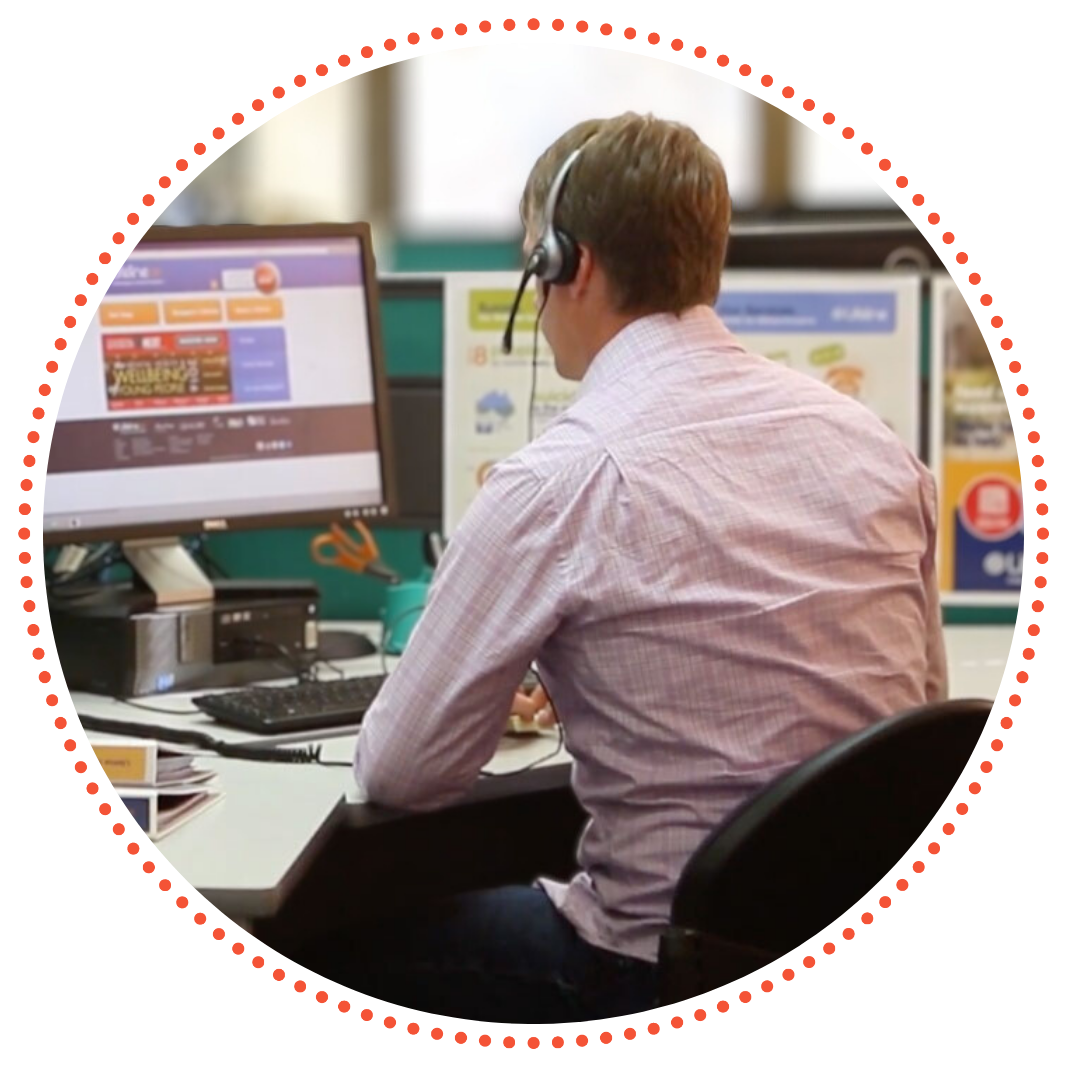A rear-view photo over Dennis' shoulder as he takes a call for support at a Lifeline Crisis Support Centre