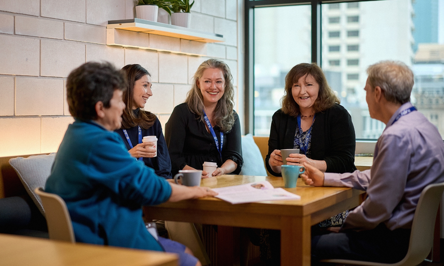 A group of Lifeline volunteer Crisis Supporters are enjoying a cuppa together